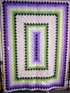 Purple and Green prints coordinate and contrast to make this perfect color combination.Top & backing are constructed of quality 100% cotton, batting is low loft polyester. Machine pieced and machine quilted by Linda Monasky. 